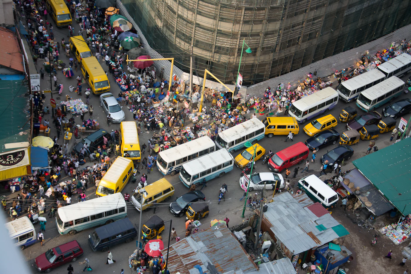 A busy Lagos street from above, traffic and market stalls